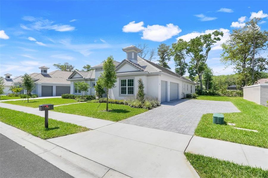 Front exterior of a new home in Toscana, Palm Coast, FL, highlighting curb appeal (Image 24). Front exterior of a new home in Toscana, Palm Coast, FL, highlighting curb appeal (Image 24).