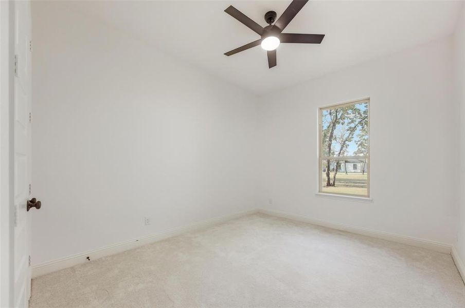 Spare room with carpet floors and ceiling fan
