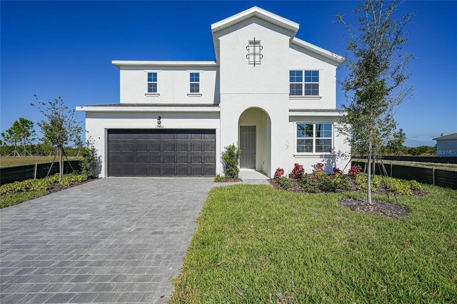Front exterior of a new home in Turnleaf, Punta Gorda, FL, highlighting curb appeal (Image 1). Front exterior of a new home in Turnleaf, Punta Gorda, FL, highlighting curb appeal (Image 1).