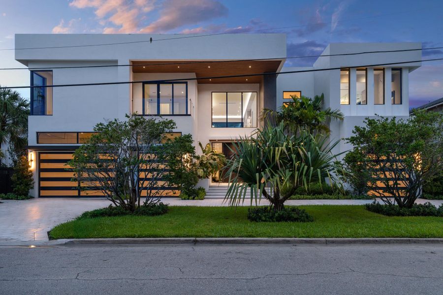 Modern architectural masterpiece with bold lines, expansive glass, and lush landscaping creating striking curb appeal. Modern architectural masterpiece with bold lines, expansive glass, and lush landscaping creating striking curb appeal.