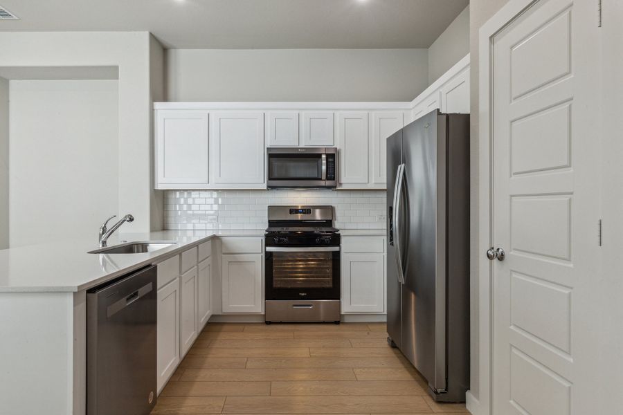 Kitchen in the Birch home plan by Trophy Signature Homes – REPRESENTATIVE PHOTO