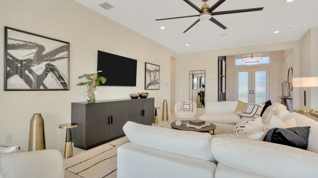 The Living Room of a DRB Homes Grand Eider model, which is a home plan offered at Serengeti in Spring Hill, FL.