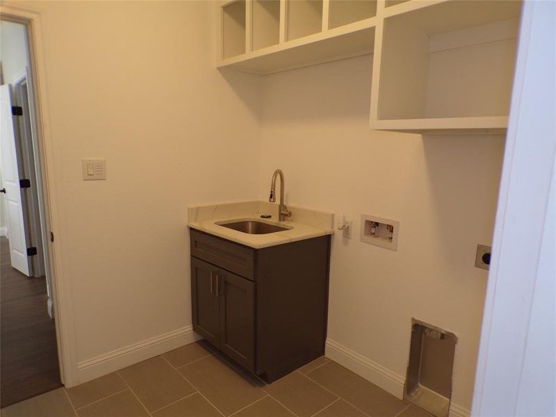 Laundry area featuring sink, dark hardwood / wood-style floors, hookup for an electric dryer, and hookup for a washing machine