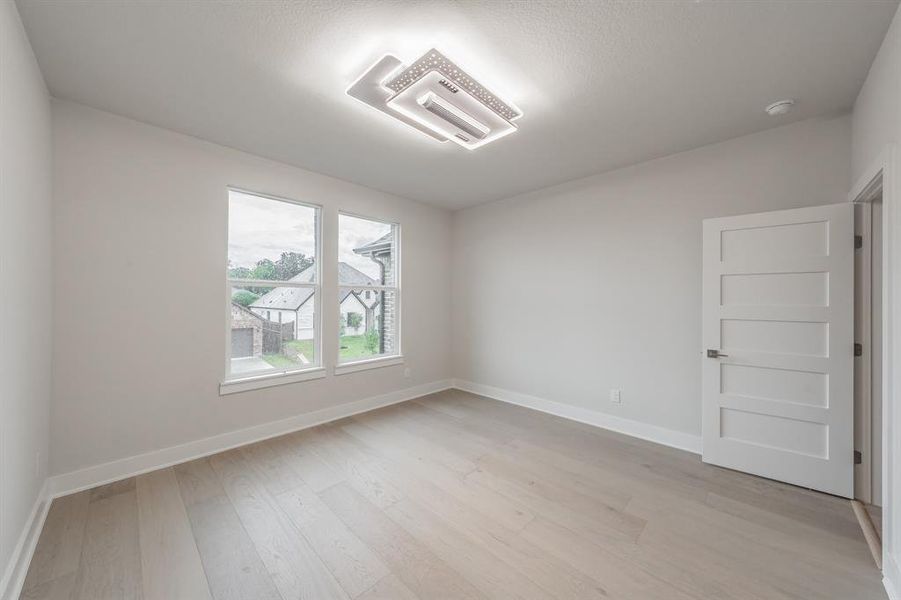 Unfurnished room featuring baseboards and light wood-style floors
