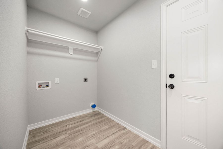 Conveniently located utility room featuring dedicated space for laundry appliances, ample storage cabinetry, and durable flooring, designed for optimal organization and functionality. Conveniently located utility room featuring dedicated space for laundry appliances, ample storage cabinetry, and durable flooring, designed for optimal organization and functionality.