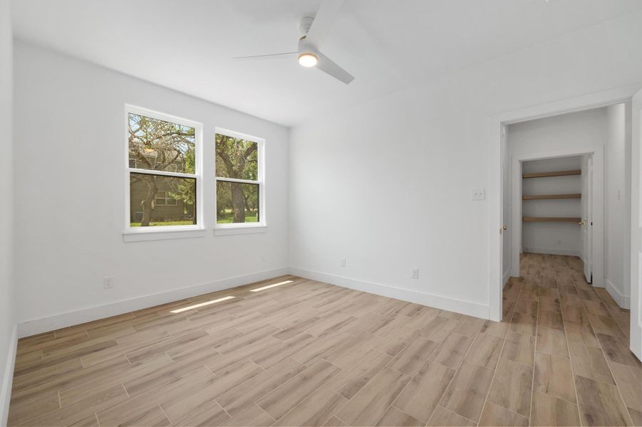 Unfurnished bedroom with wood finish floors and ceiling fan Unfurnished bedroom with wood finish floors and ceiling fan