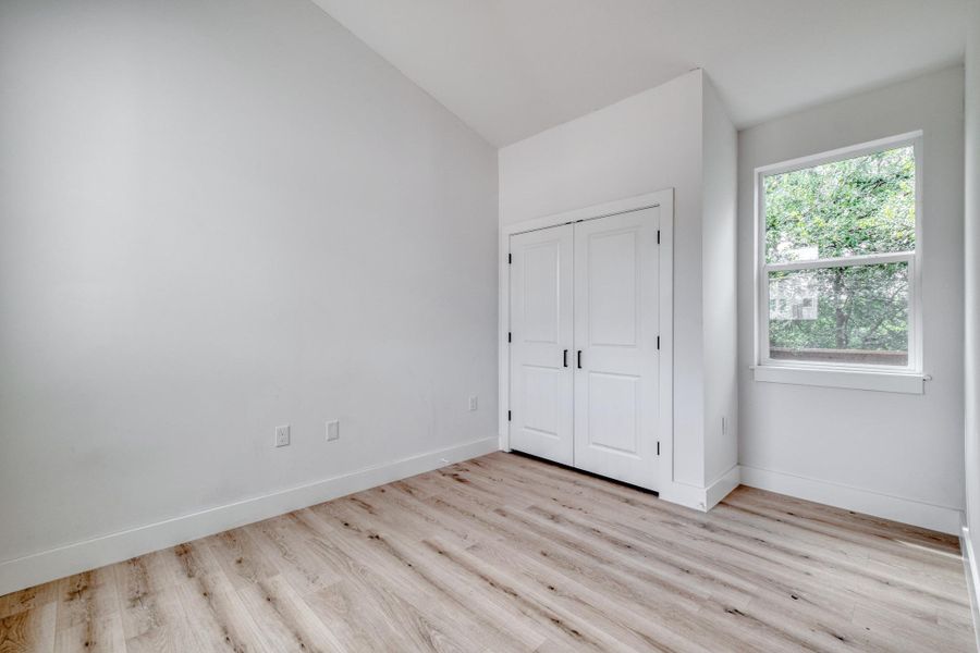 A well-lit room showcases durable wood flooring and ample storage. A well-lit room showcases durable wood flooring and ample storage.