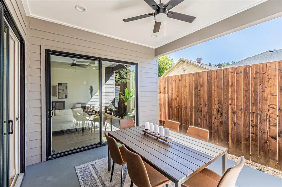 View of patio featuring outdoor dining area and a ceiling fan View of patio featuring outdoor dining area and a ceiling fan