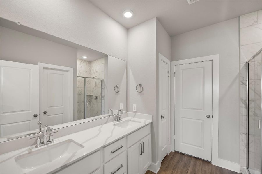 Elegant ensuite with dual vanities and separate glass shower. Elegant ensuite with dual vanities and separate glass shower.
