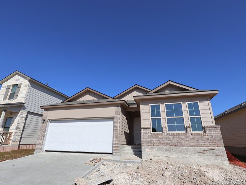 Front exterior of a new home in Hunters Ranch, San Antonio, TX, highlighting curb appeal (Image 2). Front exterior of a new home in Hunters Ranch, San Antonio, TX, highlighting curb appeal (Image 2).