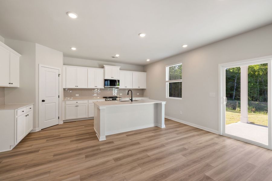A kitchen with white cabinets.