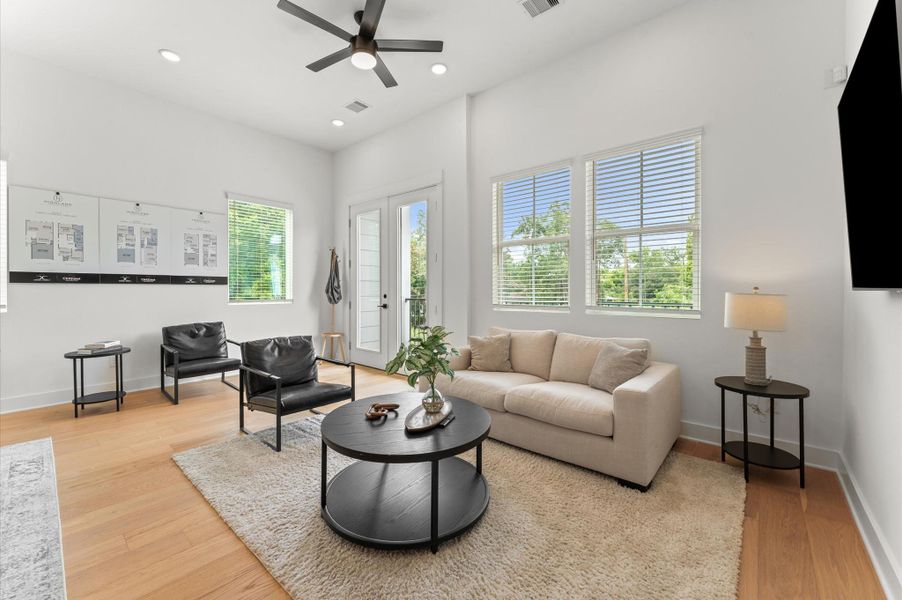 Airy and inviting open-concept living space located on the second floor, thoughtfully designed to enhance both comfort and flow. The area features high ceilings, expansive windows, and cohesive flooring that unify the living, dining, and kitchen zones. Elegant French doors serve as a striking focal point, leading out to a private balcony that extends the living space outdoors—perfect for morning coffee or evening unwinding. Airy and inviting open-concept living space located on the second floor, thoughtfully designed to enhance both comfort and flow. The area features high ceilings, expansive windows, and cohesive flooring that unify the living, dining, and kitchen zones. Elegant French doors serve as a striking focal point, leading out to a private balcony that extends the living space outdoors—perfect for morning coffee or evening unwinding.