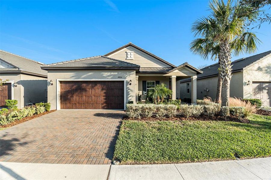 Front exterior of a new home in Angeline Active Adult: Active Adult Manors, Land O' Lakes, FL, highlighting curb appeal (Image 2).