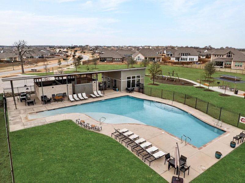 A second community pool with a patio area and a residential view