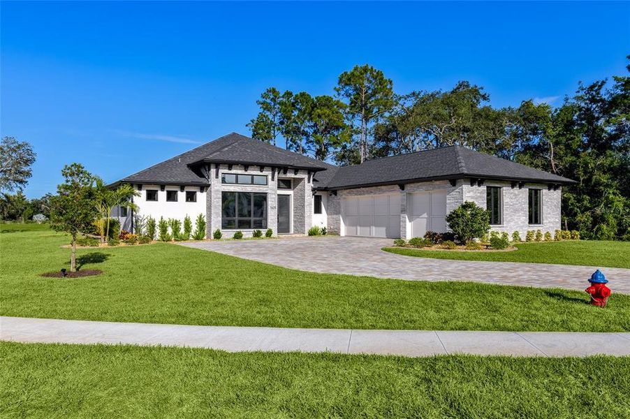 Front exterior of a new home in , New Smyrna Beach, FL, highlighting curb appeal (Image 28). Front exterior of a new home in , New Smyrna Beach, FL, highlighting curb appeal (Image 28).