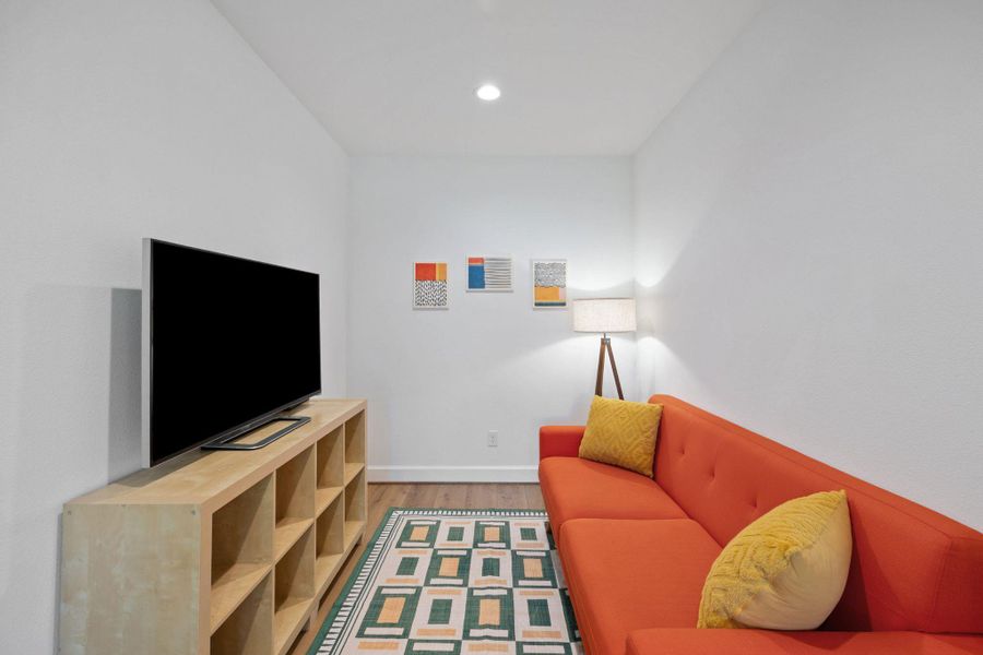 Living room with wood finished floors and recessed lighting