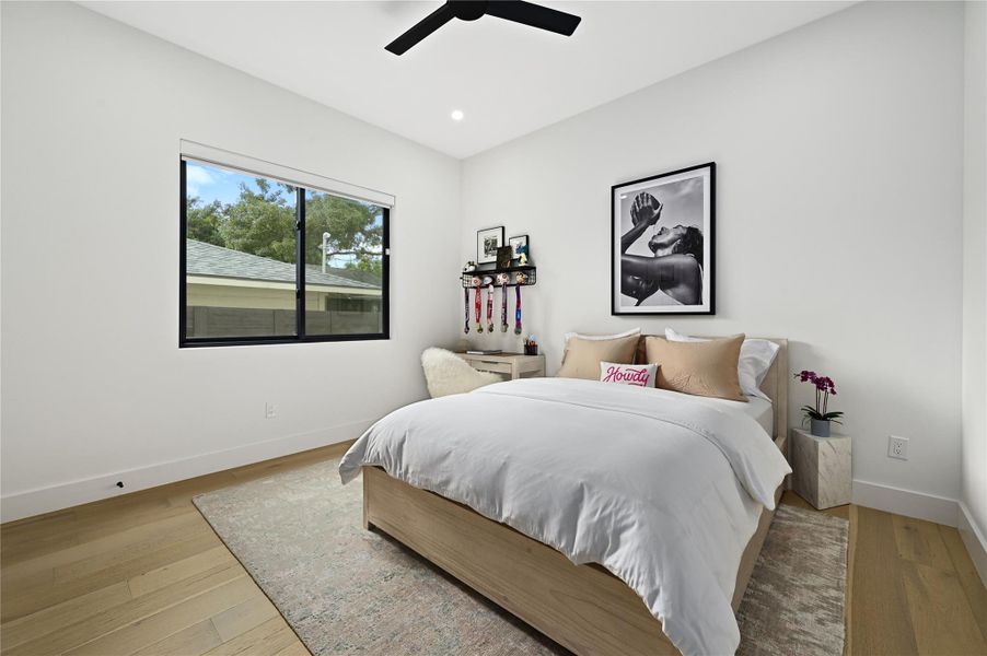 Bedroom featuring recessed lighting, wood finished floors, baseboards, and ceiling fan