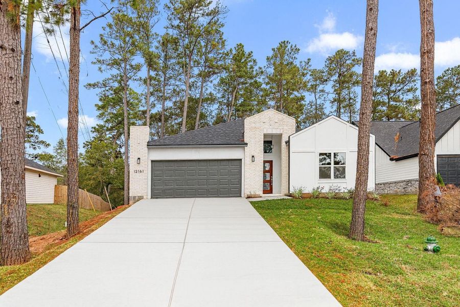 Front exterior of a new home in , Conroe, TX, highlighting curb appeal (Image 22). Front exterior of a new home in , Conroe, TX, highlighting curb appeal (Image 22).