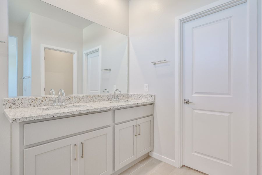 A bathroom with white cabinets. A bathroom with white cabinets.