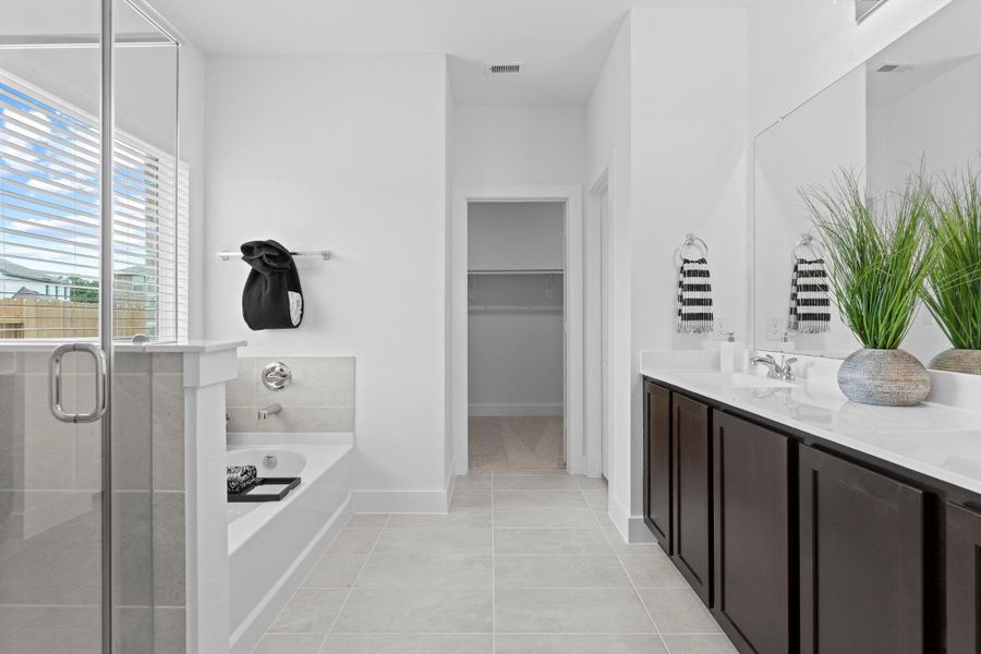 Spa-like primary bath offers glass-enclosed super shower, double vanity with elegant, cultured marble countertops, and access to a generous walk-in closet—designed for both style and convenience. **Image Representative of Plan Only and May Vary as Built**. Spa-like primary bath offers glass-enclosed super shower, double vanity with elegant, cultured marble countertops, and access to a generous walk-in closet—designed for both style and convenience. **Image Representative of Plan Only and May Vary as Built**.