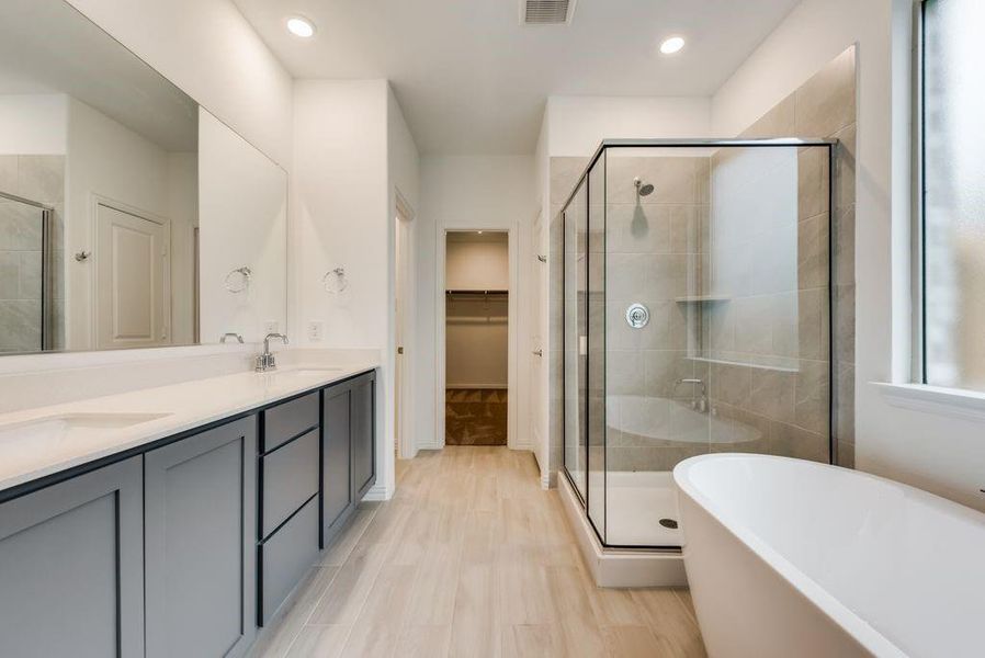 Bathroom featuring hardwood / wood-style flooring, vanity, and independent shower and bath