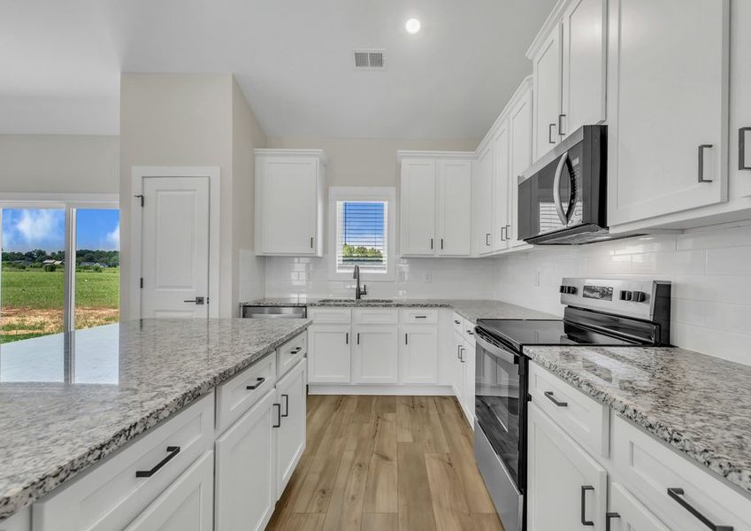 The kitchen has designer wood cabinetry.