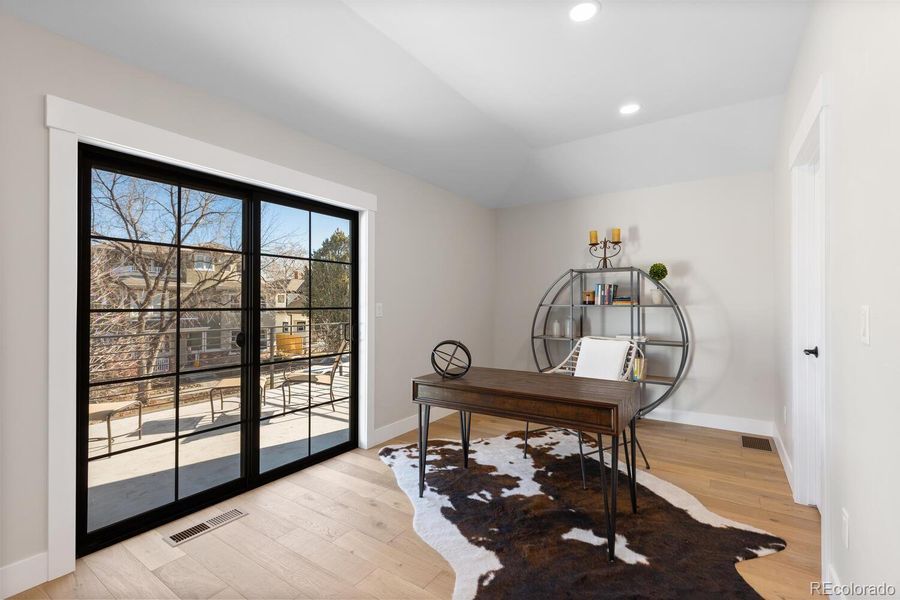 Loft that opens to a large rooftop deck throughmodern sliding doors Loft that opens to a large rooftop deck throughmodern sliding doors