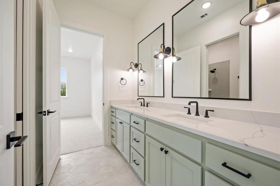 Bathroom featuring tile patterned floors and dual bowl vanity