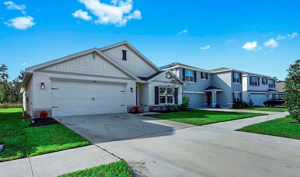 Front exterior of a new home in Berry Bay, Wimauma, FL, highlighting curb appeal (Image 1). Front exterior of a new home in Berry Bay, Wimauma, FL, highlighting curb appeal (Image 1).