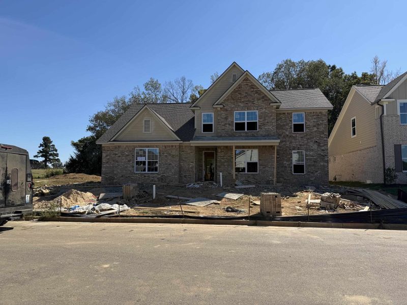 Two-story residence featuring a brick and siding exterior with a covered front entrance