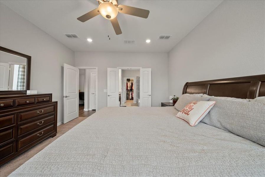 Primary bedroom with bay windows.