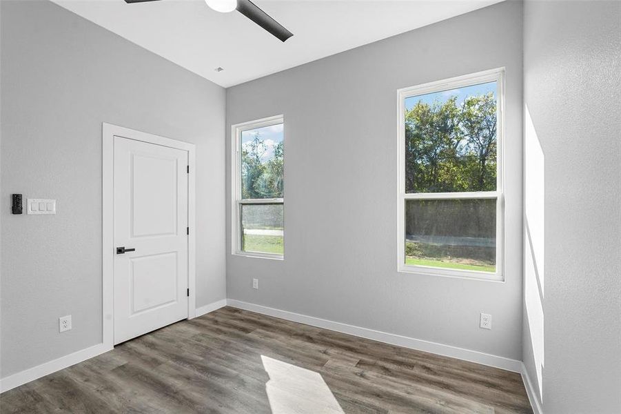 Spare room featuring hardwood / wood-style floors and ceiling fan