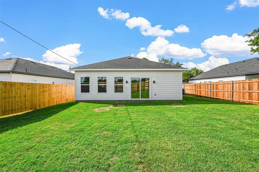 Rear view of house with a lawn