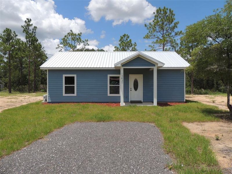 Front exterior of a new home in , Williston, FL, highlighting curb appeal (Image 1).