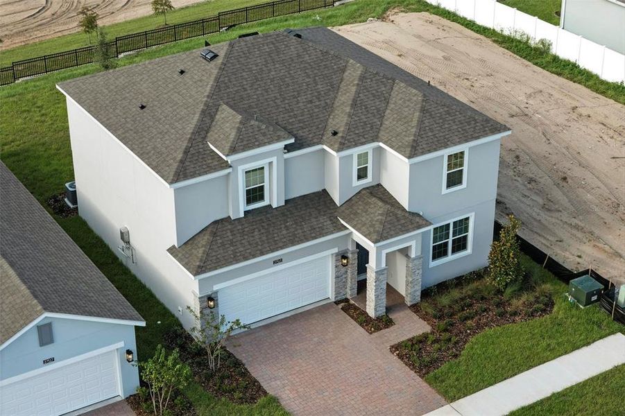 Front exterior of a new home in Eagletail Landings, Howey-in-the-Hills, FL, highlighting curb appeal (Image 14).