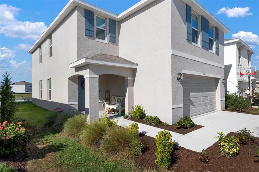 Front exterior of a new home in Bella Lago, Parrish, FL, highlighting curb appeal (Image 24).