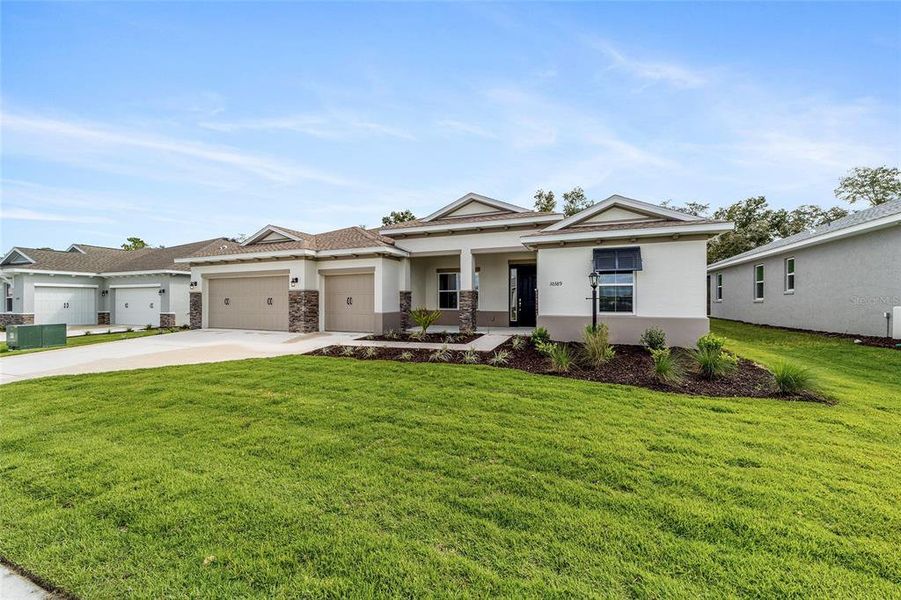 Front exterior of a new home in On Top of the World Communities, Ocala, FL, highlighting curb appeal (Image 22).