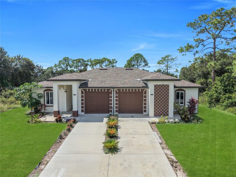 Front exterior of a new home in , Lehigh Acres, FL, highlighting curb appeal (Image 6).