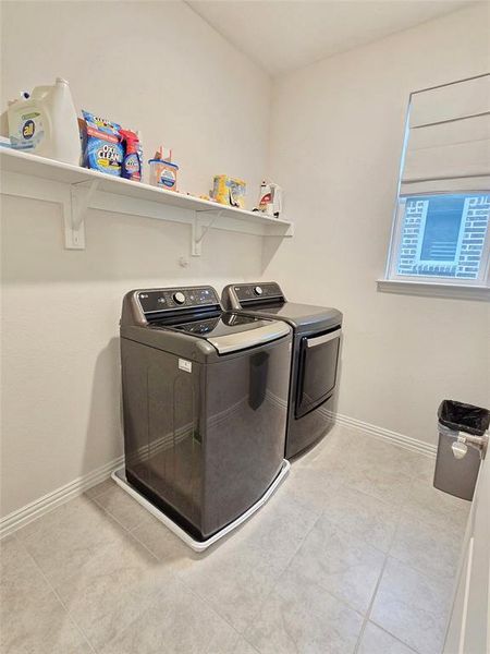 Laundry room located upstairs near primary suite.