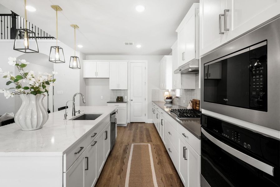 Culinary delights await in this bright kitchen with modern appliances and an open-concept layout.