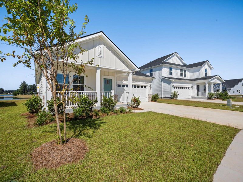 Front exterior of a new home in The Coves at Lakes of Cane Bay, Summerville, SC, highlighting curb appeal (Image 2). Front exterior of a new home in The Coves at Lakes of Cane Bay, Summerville, SC, highlighting curb appeal (Image 2).