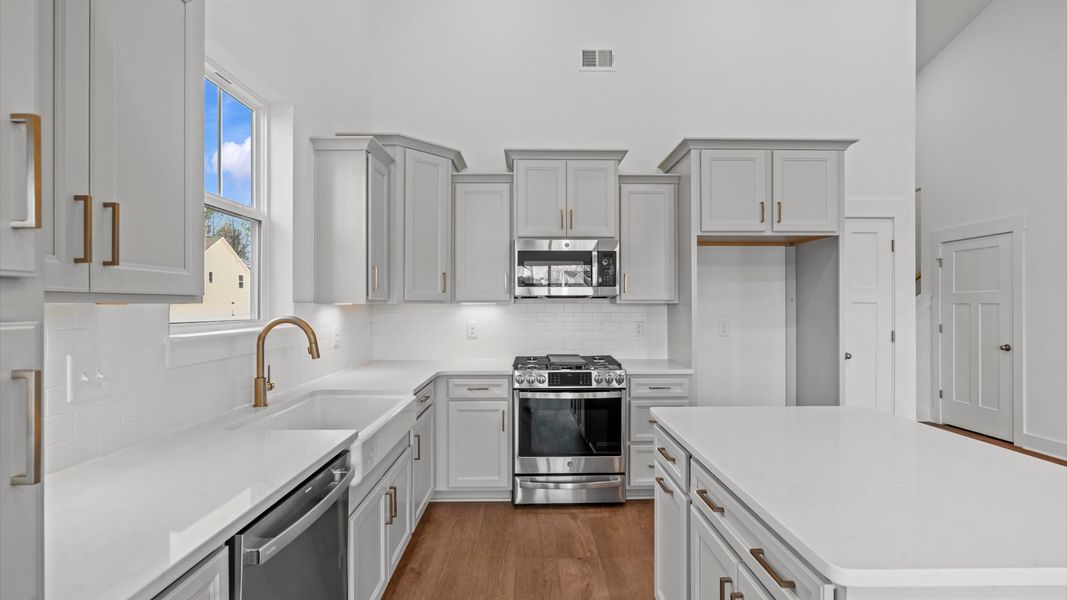 Modern kitchen with streamlined island for easy prep, storage, and gathering