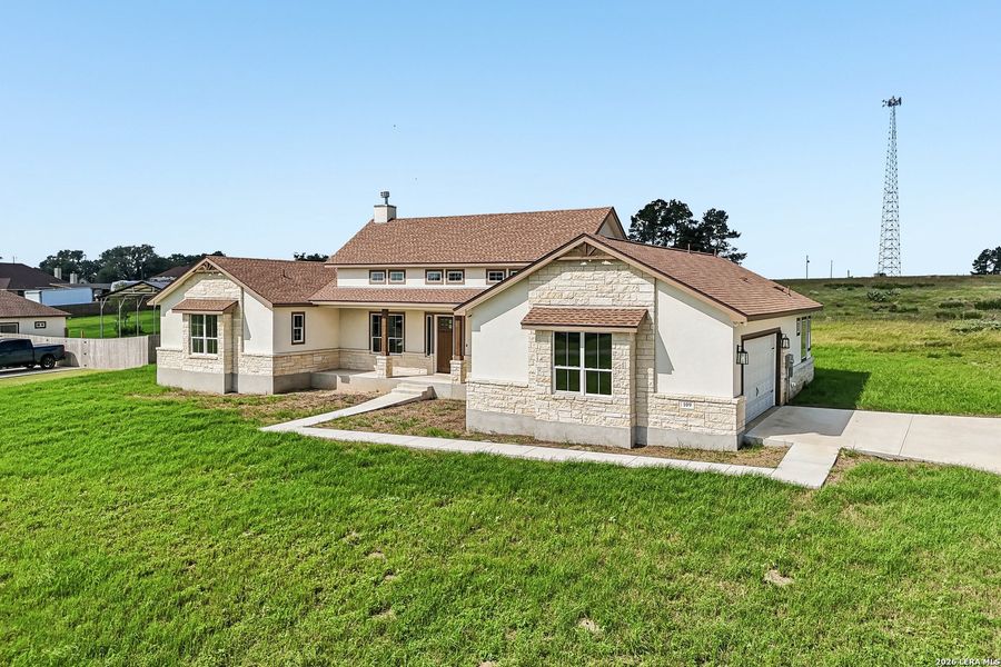Front exterior of a new home in , Floresville, TX, highlighting curb appeal (Image 1). Front exterior of a new home in , Floresville, TX, highlighting curb appeal (Image 1).