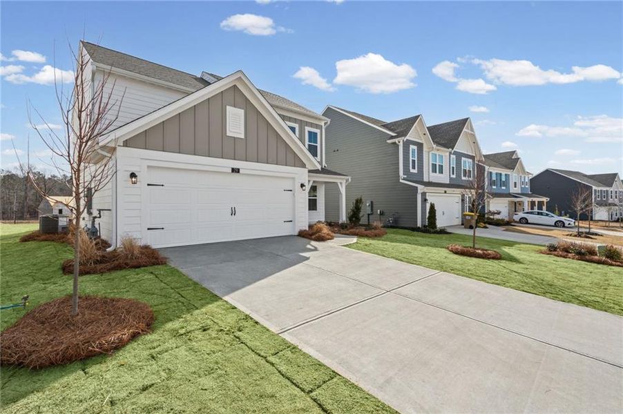 Front exterior of a new home in Twin Lakes, Hoschton, GA, highlighting curb appeal (Image 19). Front exterior of a new home in Twin Lakes, Hoschton, GA, highlighting curb appeal (Image 19).