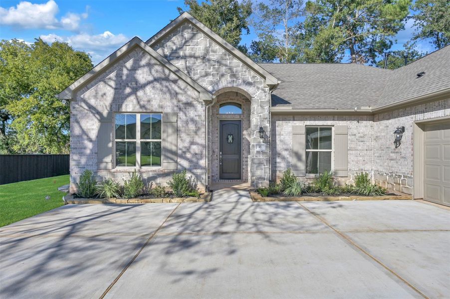 Front exterior of a new home in , Montgomery, TX, highlighting curb appeal (Image 1).