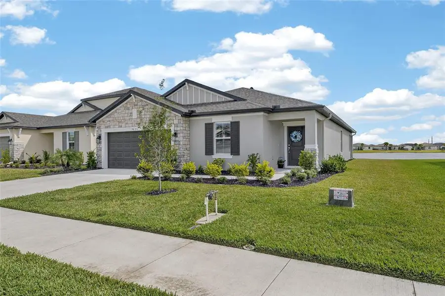 Front exterior of a new home in Summerwoods, Parrish, FL, highlighting curb appeal (Image 27).