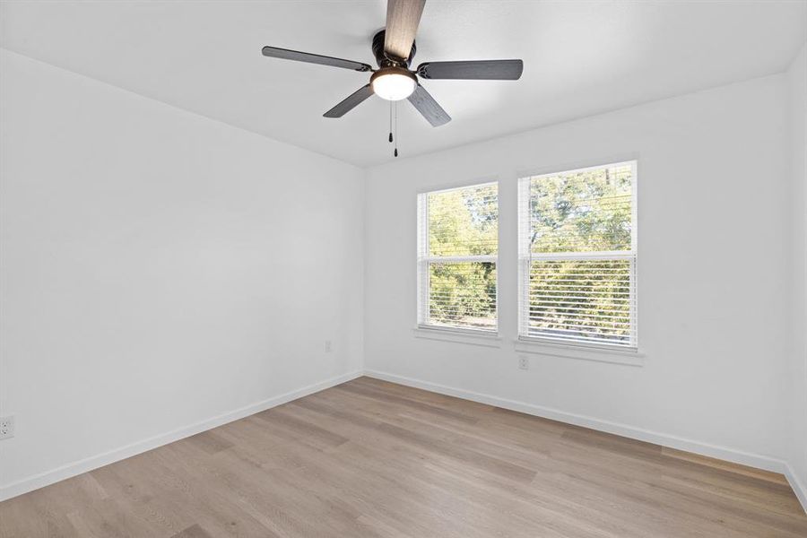 Unfurnished room featuring light hardwood / wood-style floors and ceiling fan