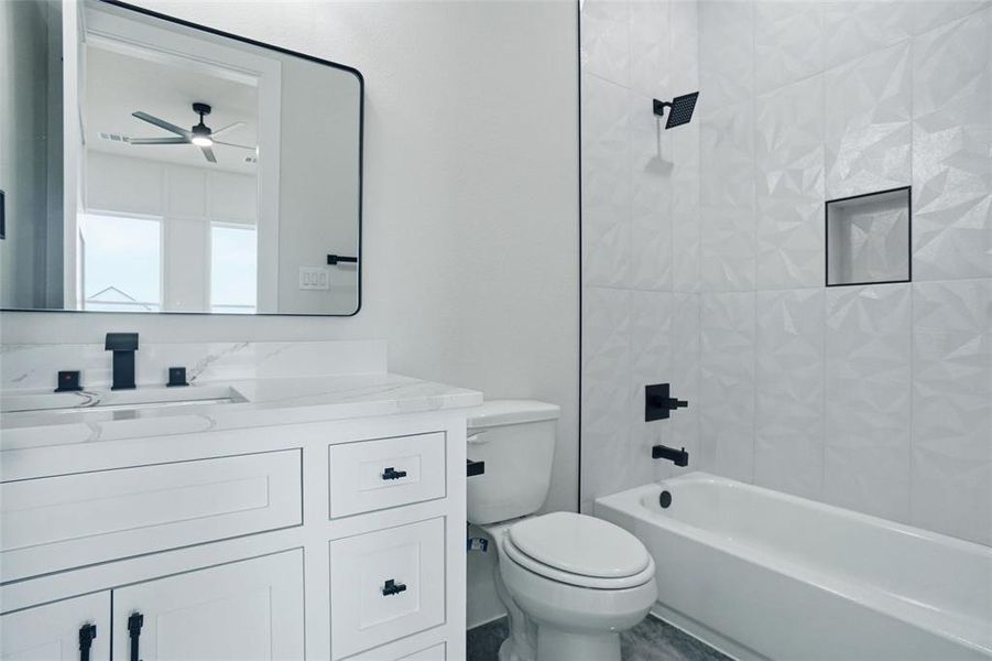 Private ensuite bathroom featuring a tub and shower combination with stylish tile surround.