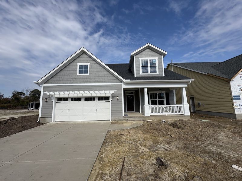 Front exterior of a new home in Riverside Cove, Wilmington, NC, highlighting curb appeal (Image 1).