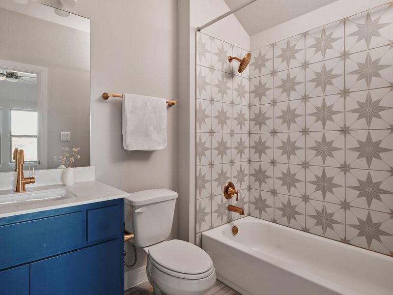 Bedroom 4 also features its own ensuite bath with a quartz vanity and shower/tub combo.